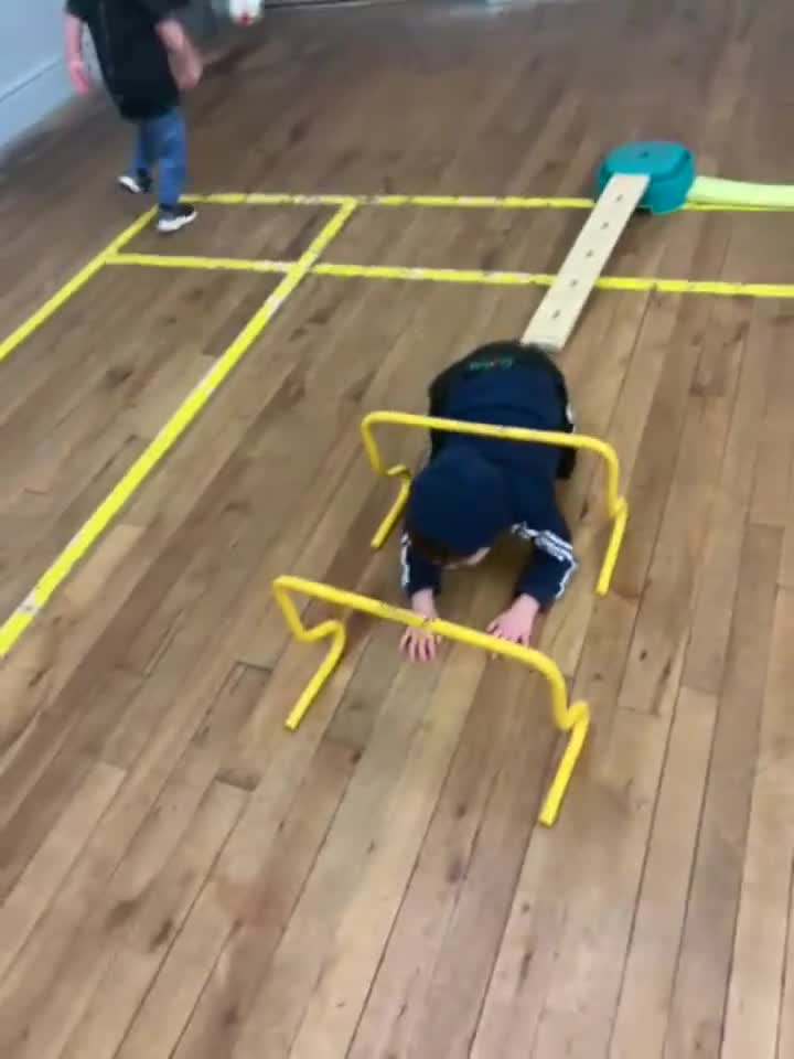 Children exploring an indoor obstacle course